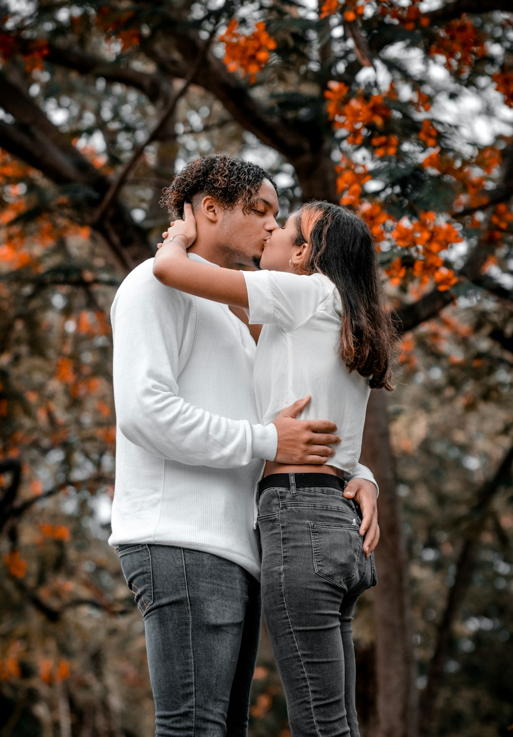 man in white sweater hugging woman in white sweater