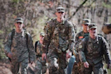men in camouflage uniform standing on field during daytime