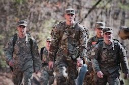 men in camouflage uniform standing on field during daytime