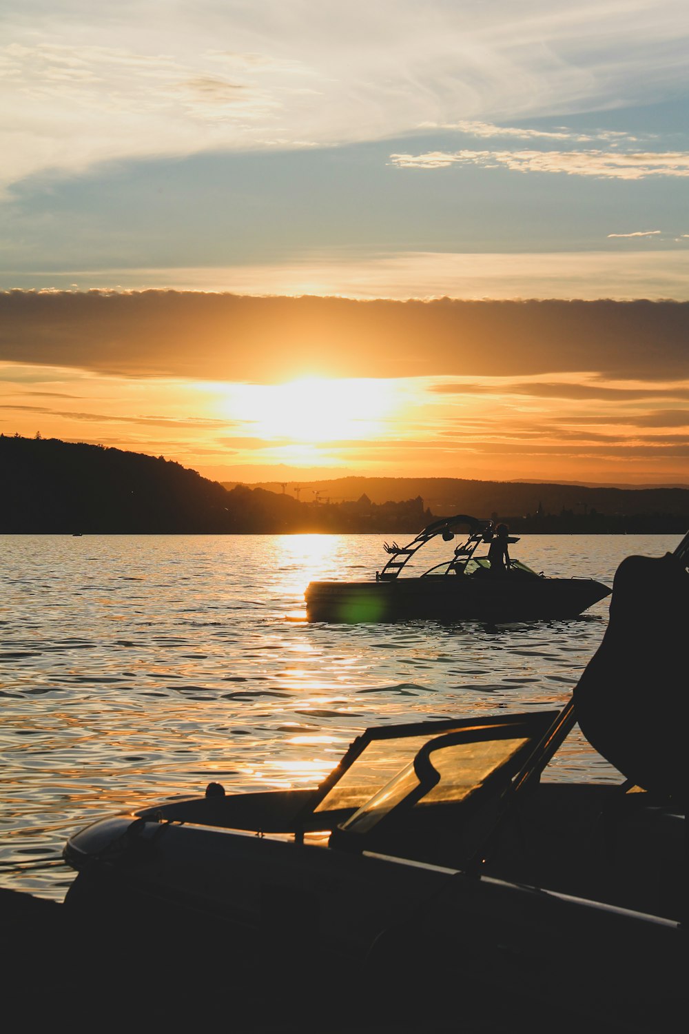 silhouette of boat on sea during sunset