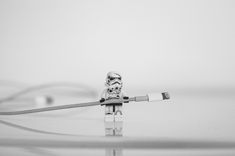 man in black and white costume holding stick