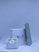 A sleek smartphone and wireless earbuds displayed on a clean white background.