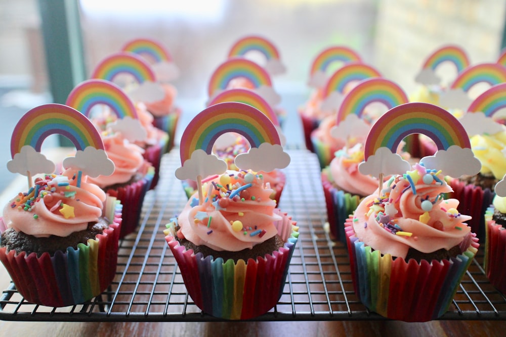 pink and green cupcake on white metal rack