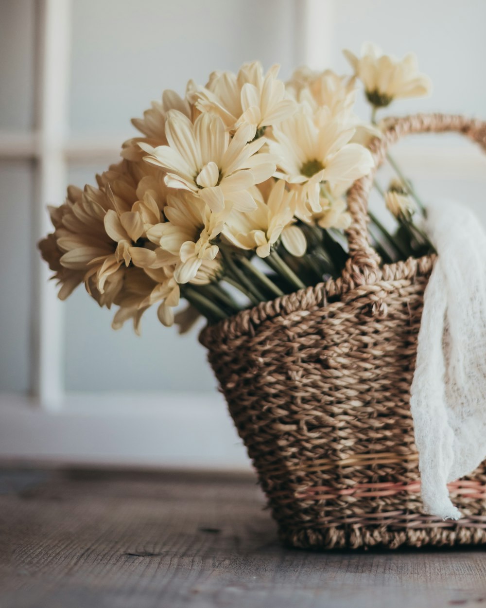 yellow flowers in brown woven basket