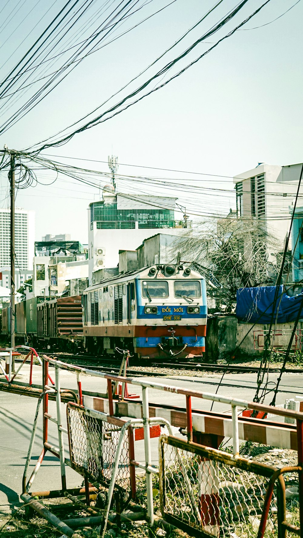 blue and brown train on rail tracks during daytime