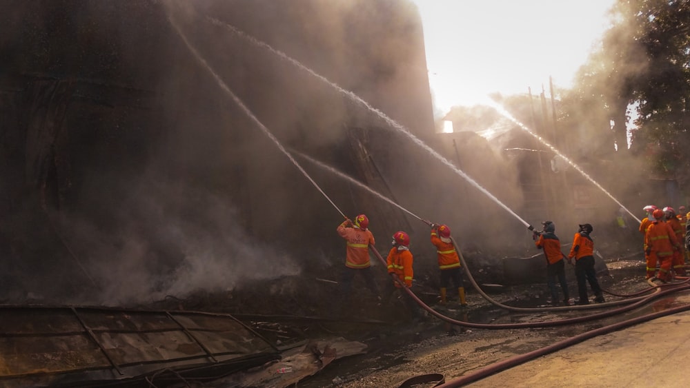 2 men standing on train rail near white smoke