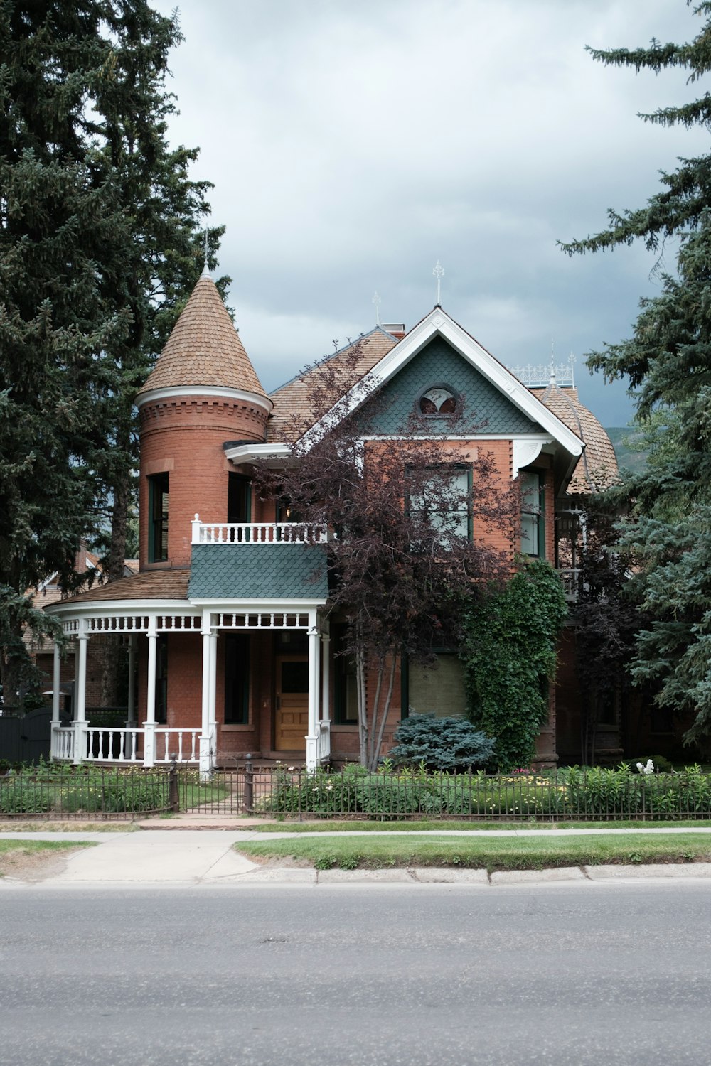 a large brick house with a white porch