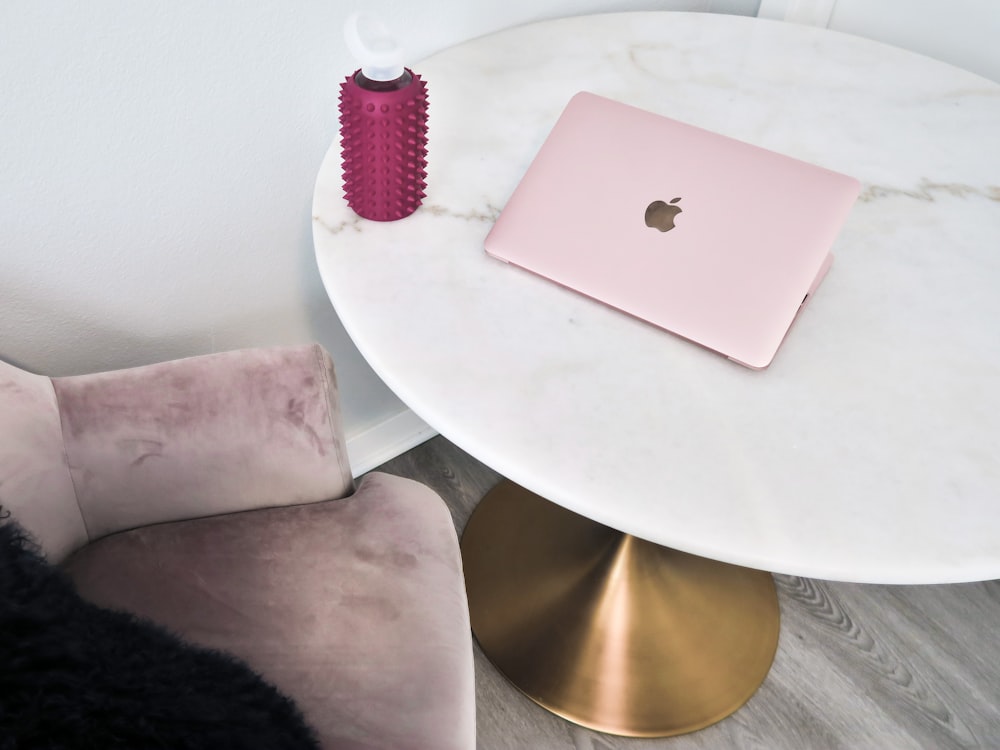 silver macbook on white round table