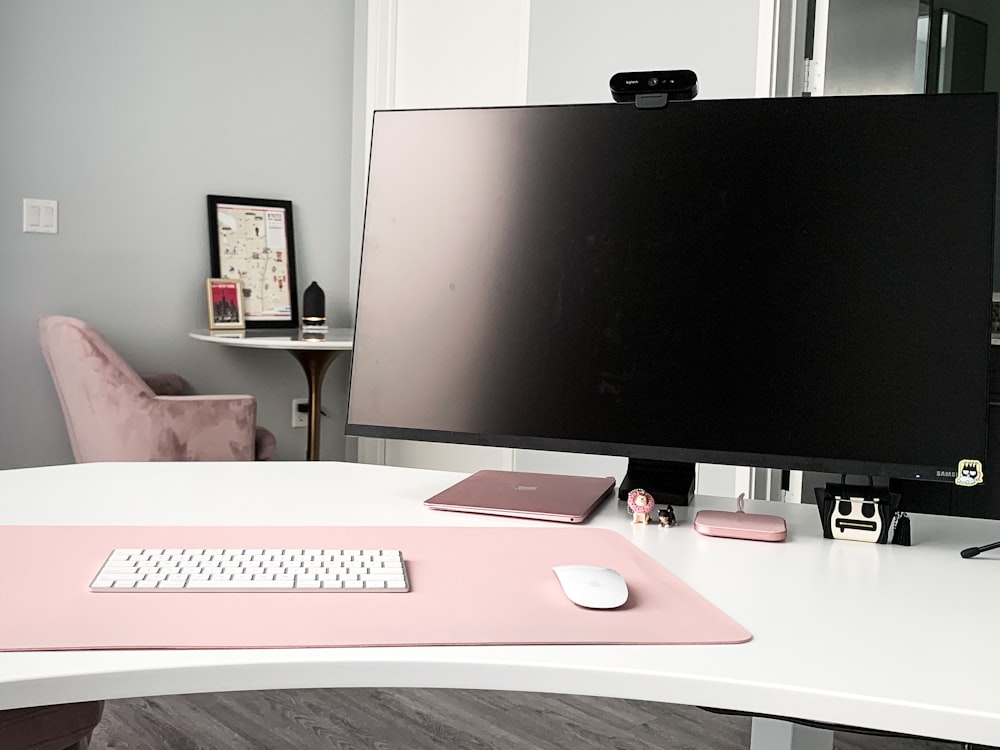 black flat screen computer monitor on brown wooden desk