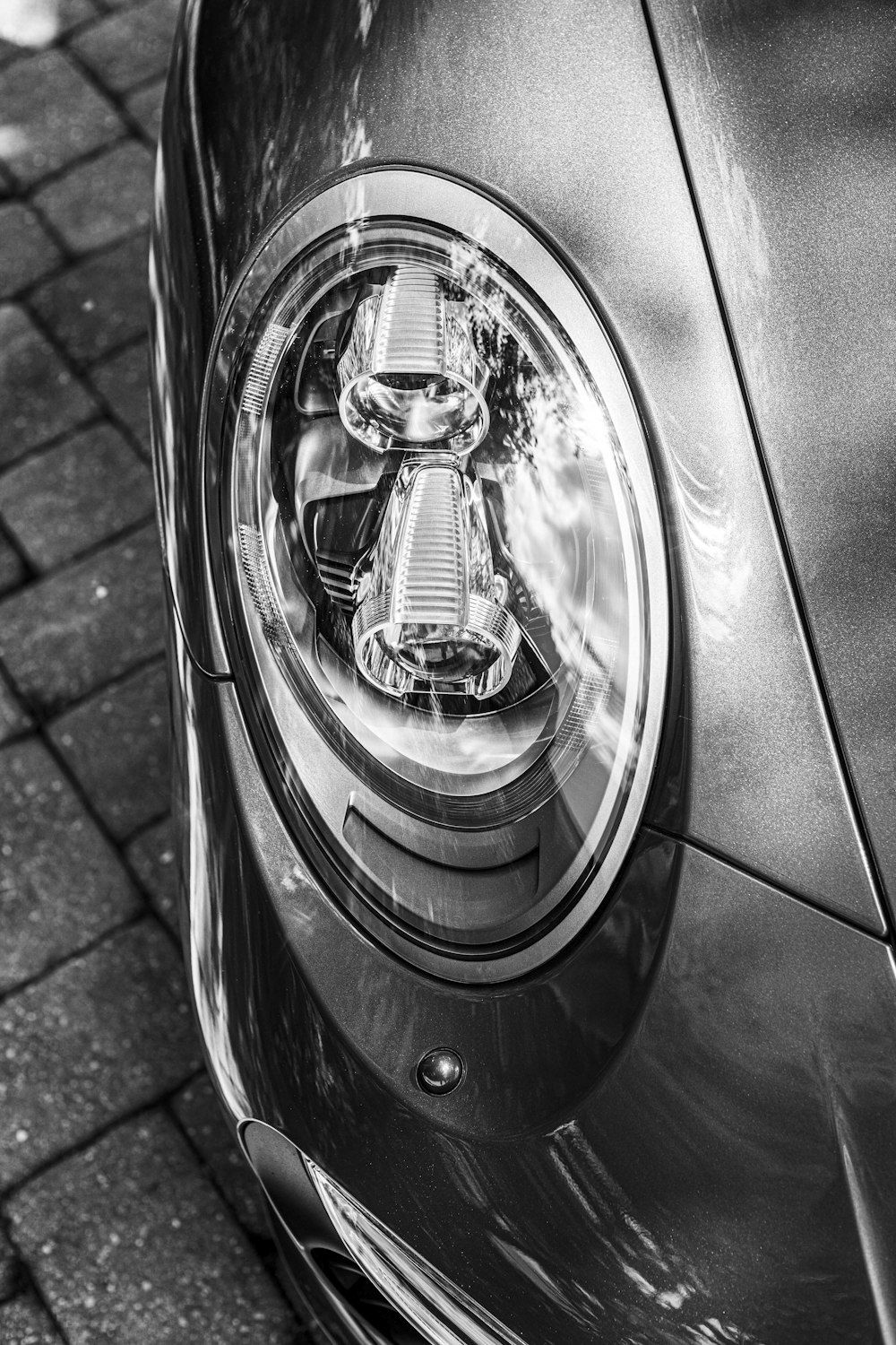 grayscale photo of car headlight