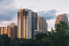 a group of tall buildings sitting next to a river