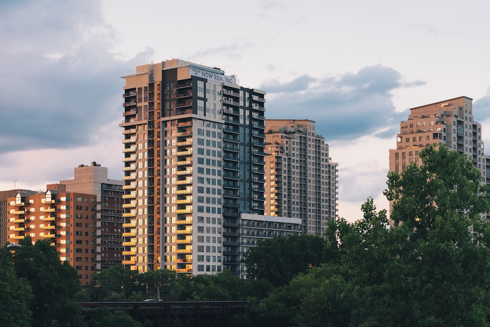 a group of tall buildings sitting next to a river