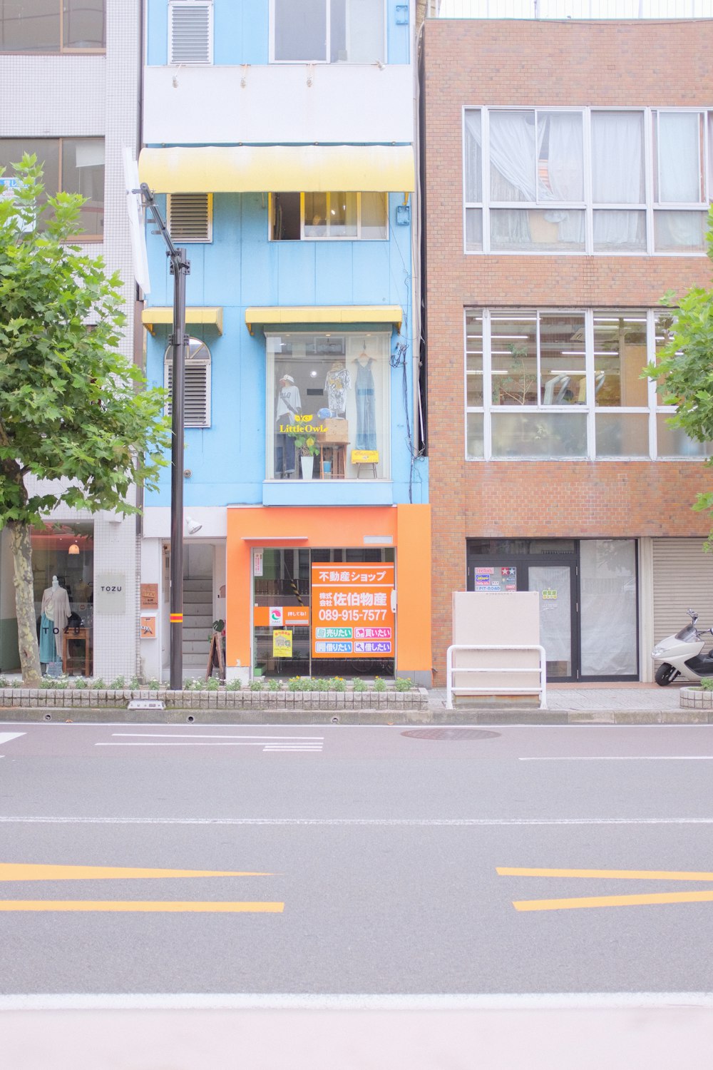 a blue and orange building on the corner of a street