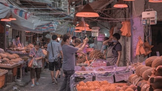 A freelancer reporter filming a live news segment in a bustling village market.
