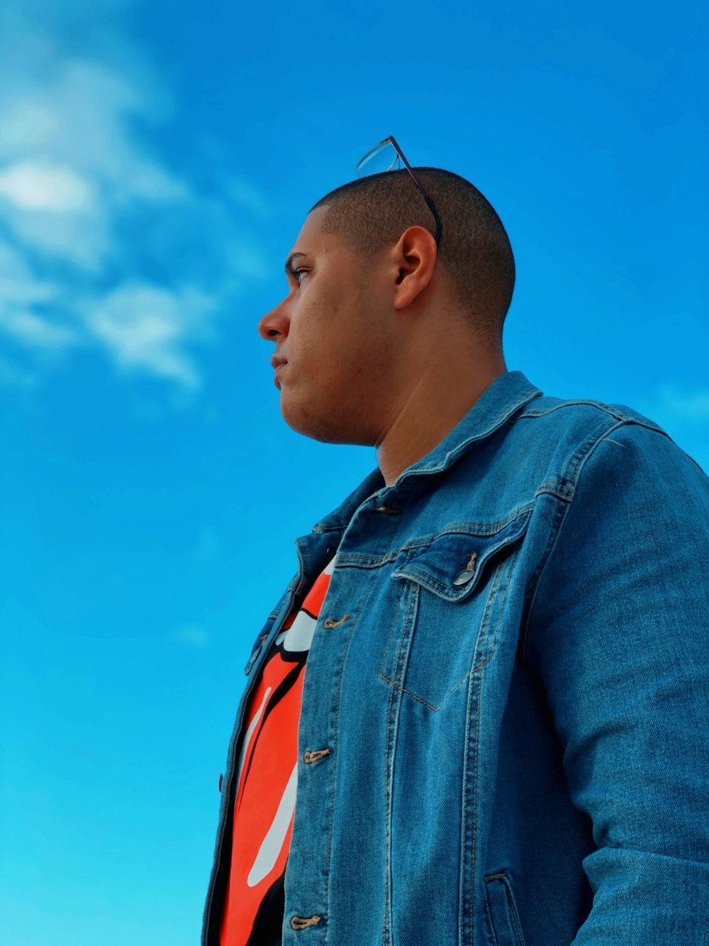 man in blue denim button up jacket under blue sky during daytime