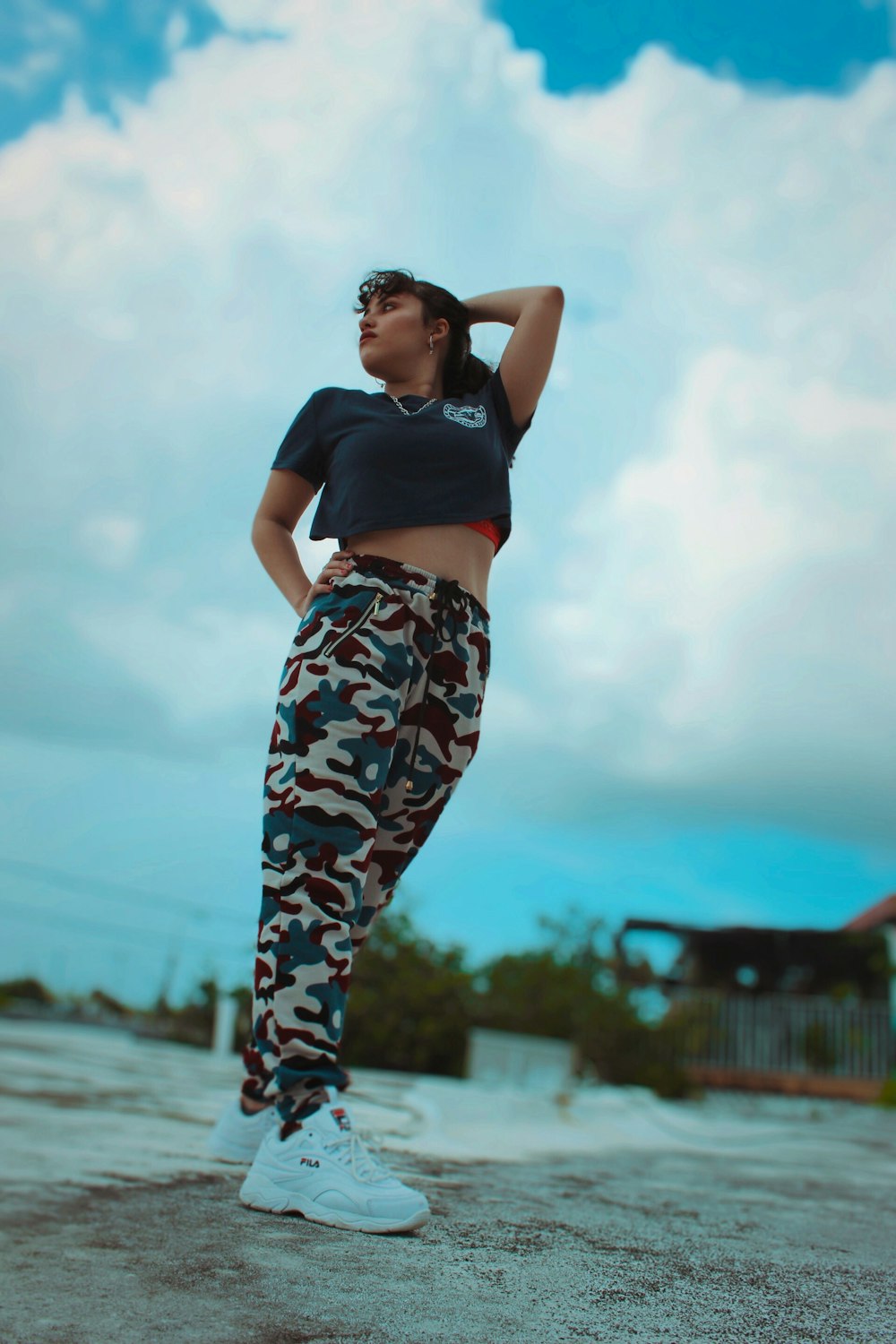woman in black crop top and white blue and pink floral pants