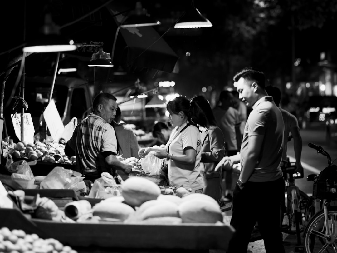 grayscale photo of people in market