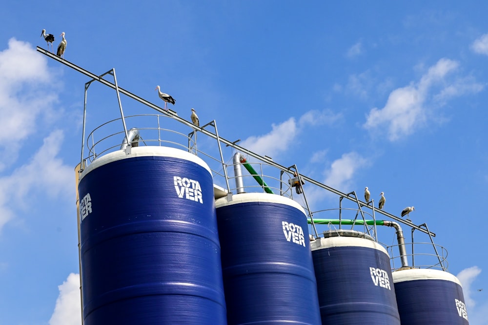 blue steel barrels under blue sky during daytime