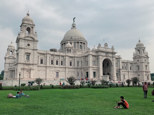 people in front of white concrete building during daytime in Victoria Memorial India