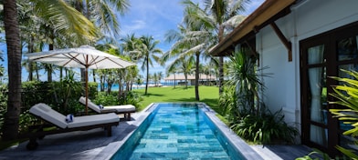 white and brown wooden house near swimming pool during daytime