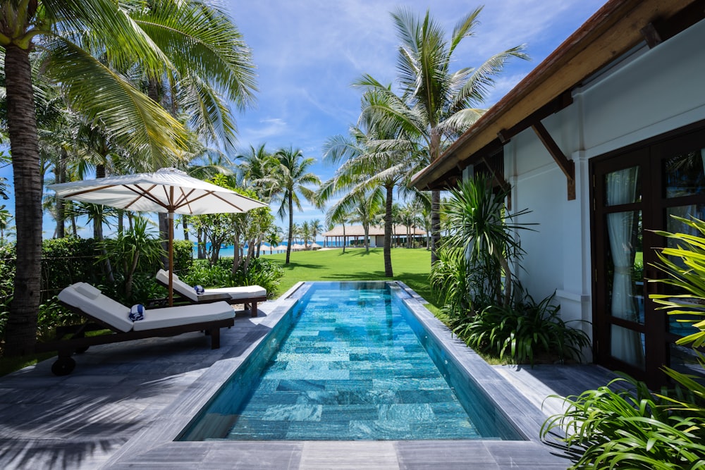 white and brown wooden house near swimming pool during daytime