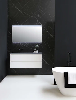 A modern bathroom vanity in white and gray tones, styled with elegant accessories.
