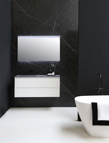 A freshly remodeled bathroom showcasing elegant tile work and a modern vanity.