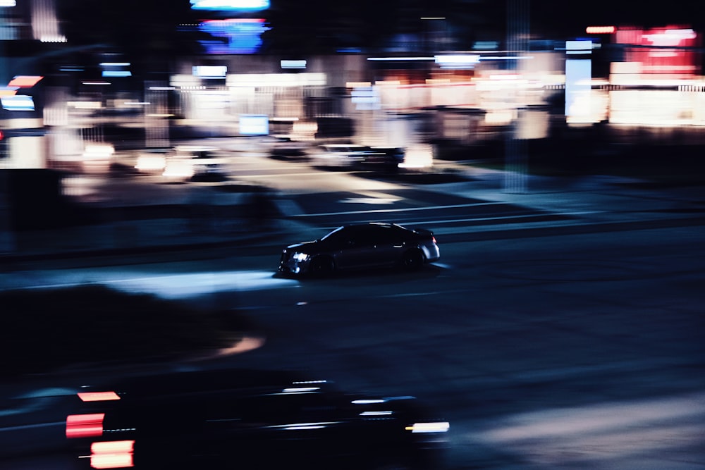black coupe on road during night time