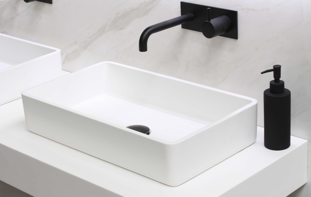 white ceramic sink with stainless steel faucet