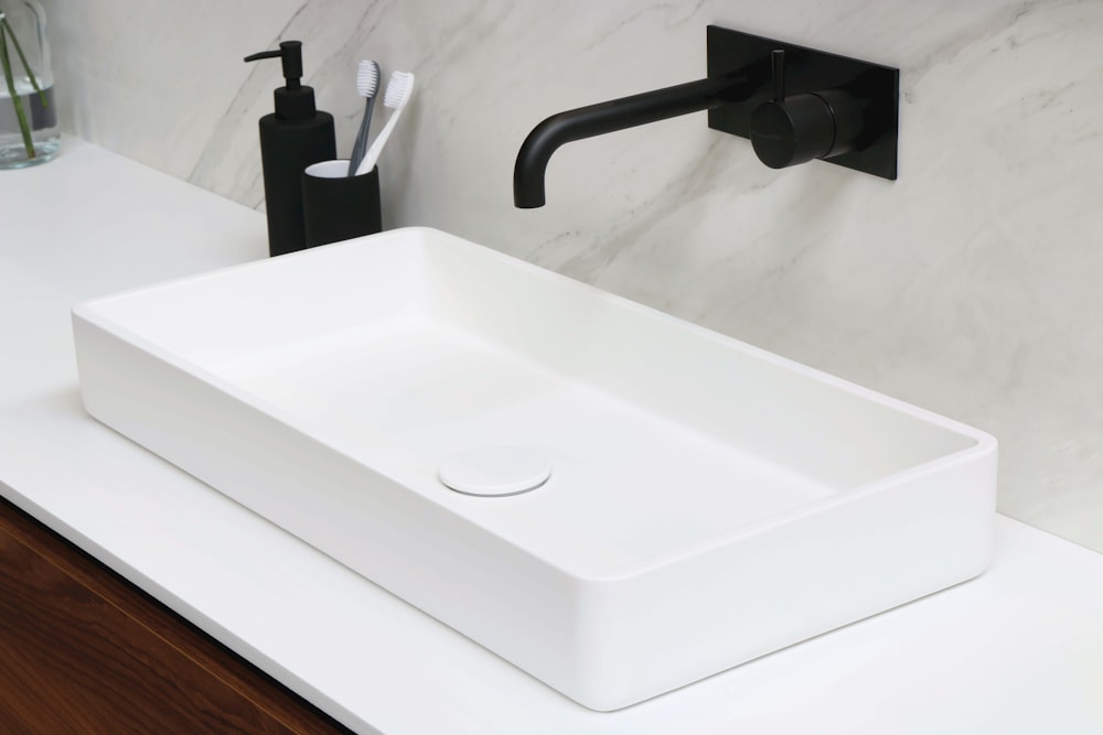 white ceramic sink with stainless steel faucet