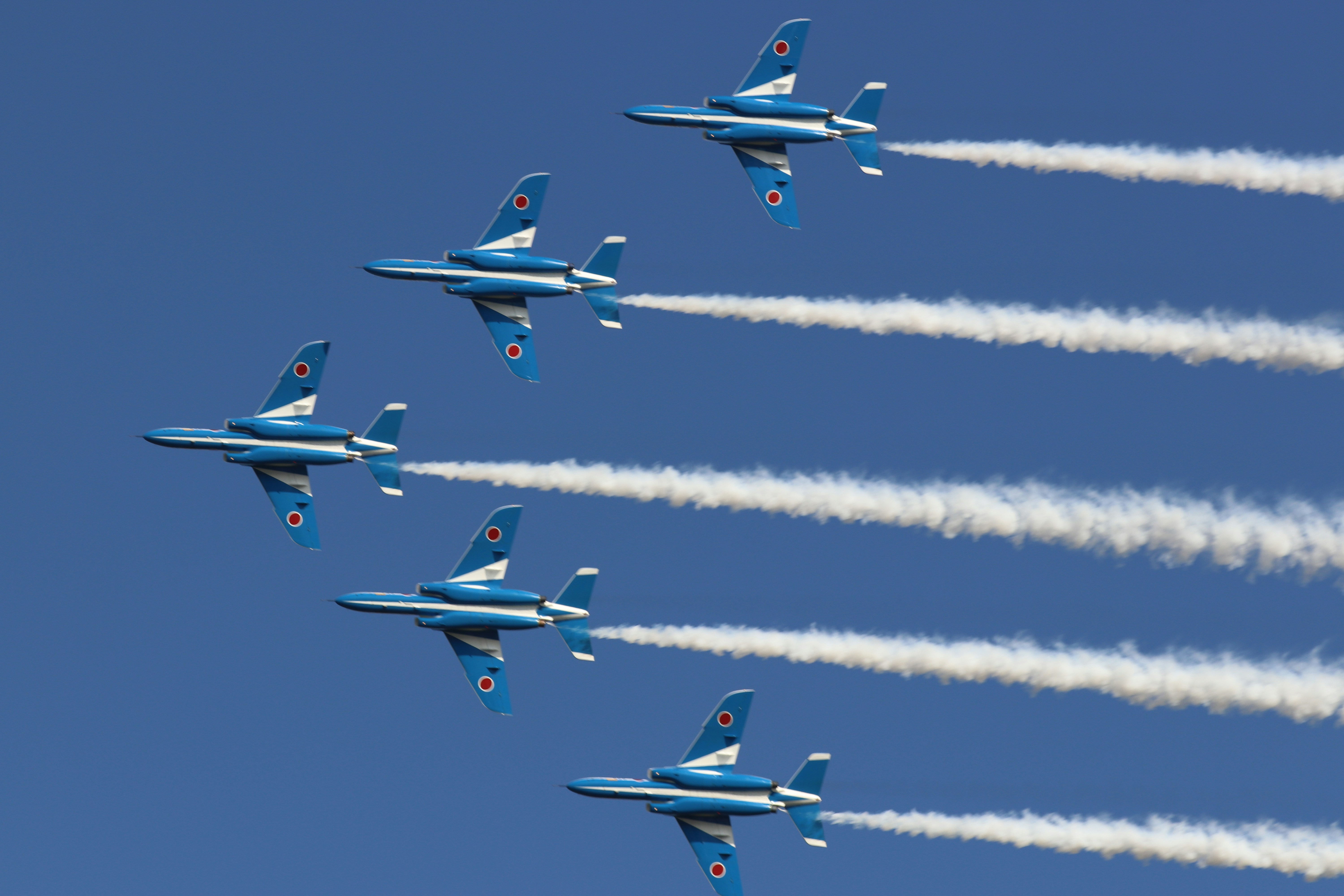 four blue and yellow jet planes