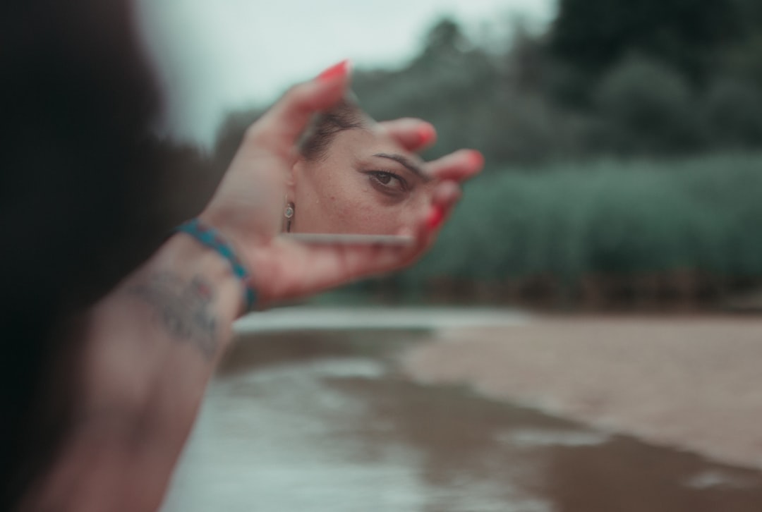 woman in silver bracelet and blue bracelet