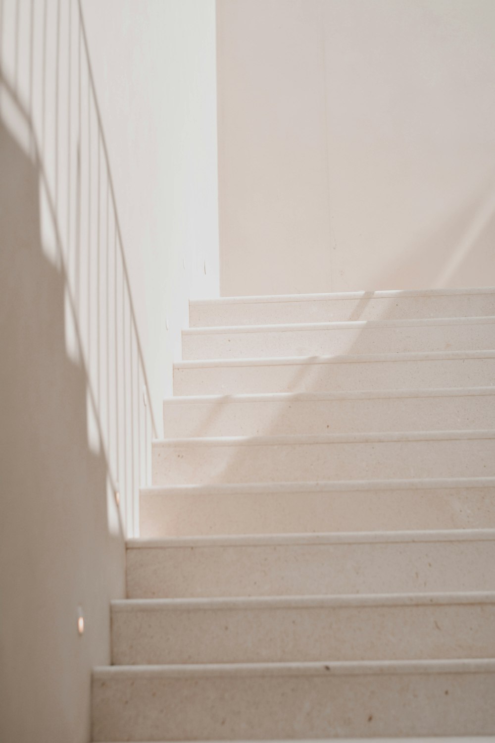 white wooden staircase with white wooden railings