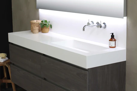 Modern interior featuring a sleek handmade tile sink integrated into a natural stone countertop.