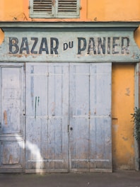 gray wooden door with white and black wall mounted signage
