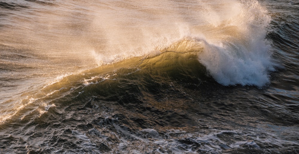 ocean waves crashing on shore during daytime