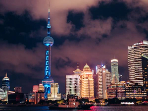 A vibrant city skyline blending iconic landmarks from Poland and Germany under a clear blue sky.