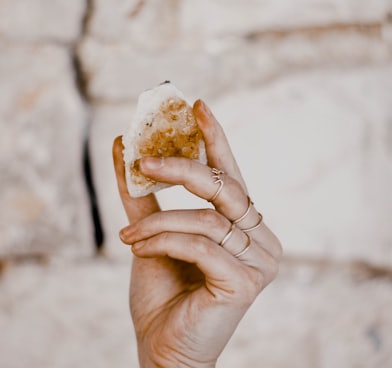 person holding bread with cheese
