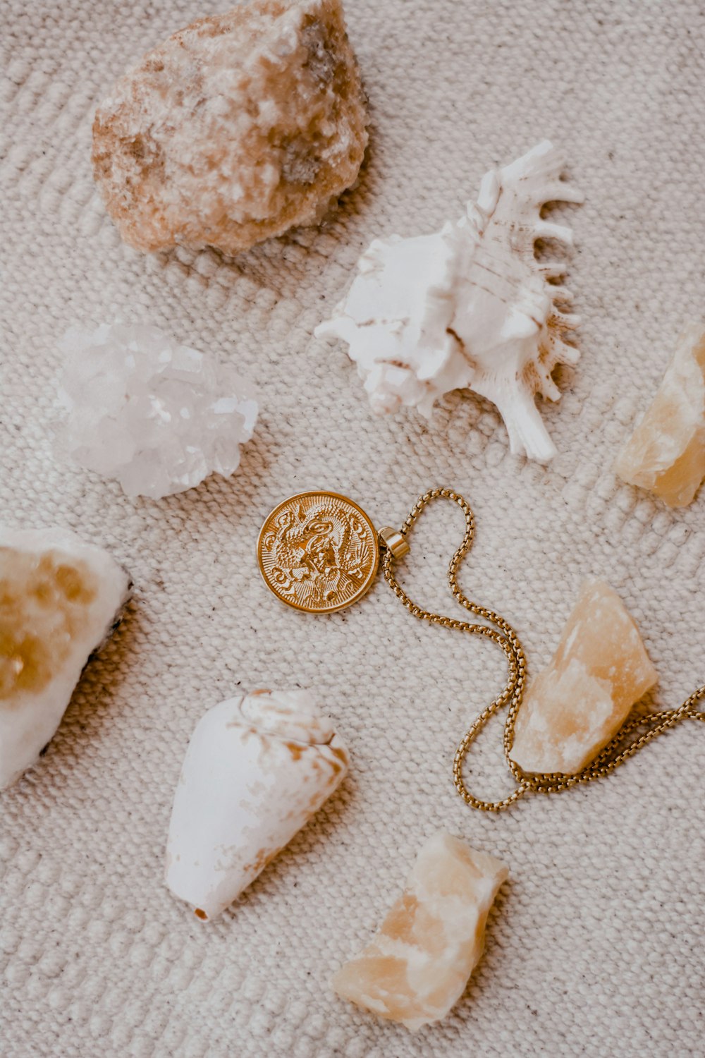 gold round coins on white textile