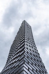gray concrete building under cloudy sky during daytime