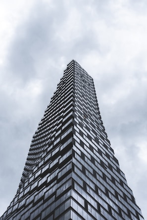 gray concrete building under cloudy sky during daytime