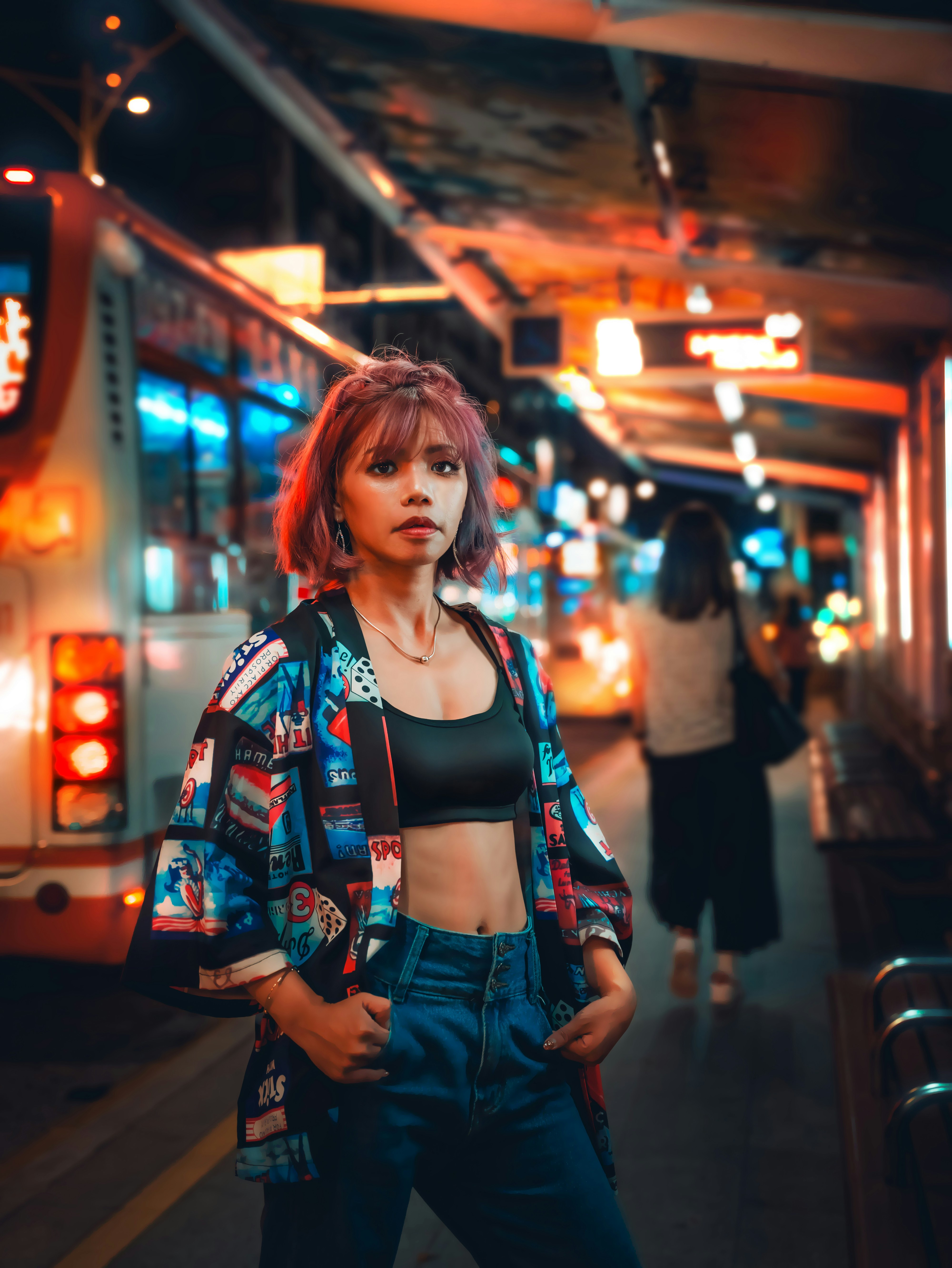 woman in blue denim jacket standing near store