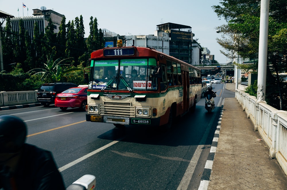 red and white bus on road during daytime