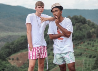 man in white crew neck t-shirt and red shorts holding girl in white t-shirt