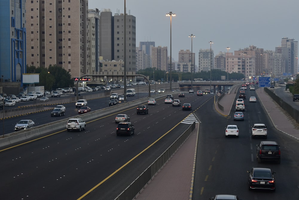 cars on road near high rise buildings during daytime