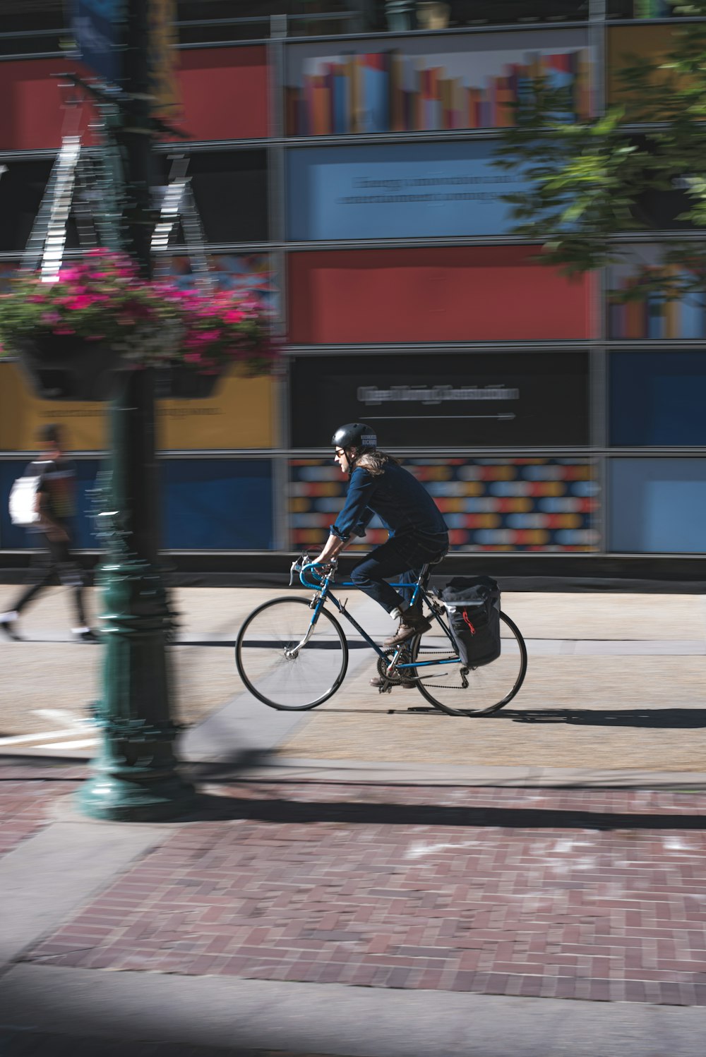 man in black jacket riding on bicycle during daytime