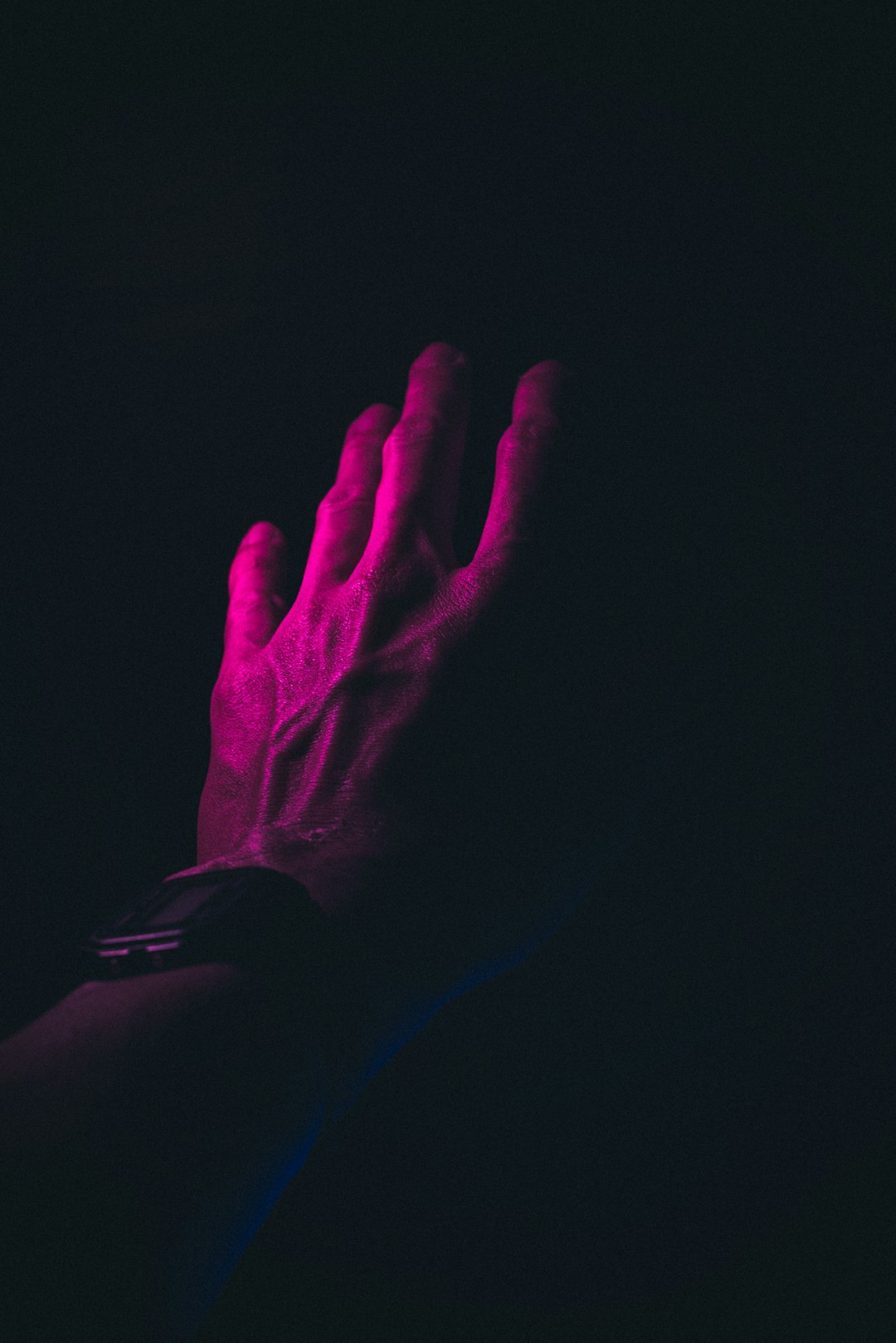 persons hand on black background