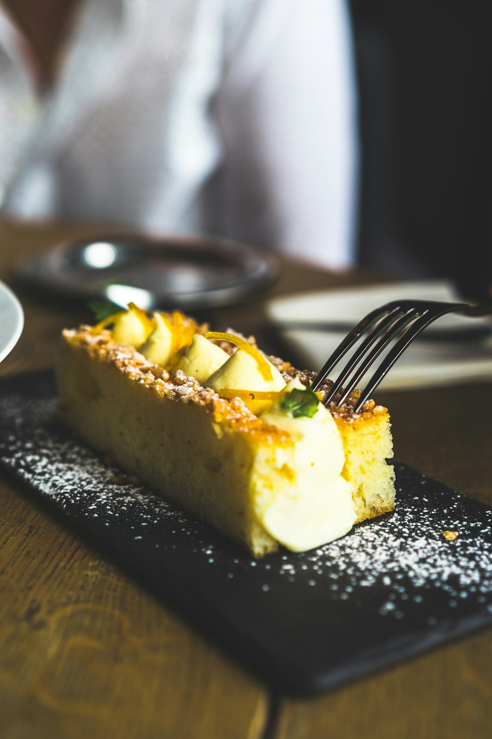 sliced cake on black plate