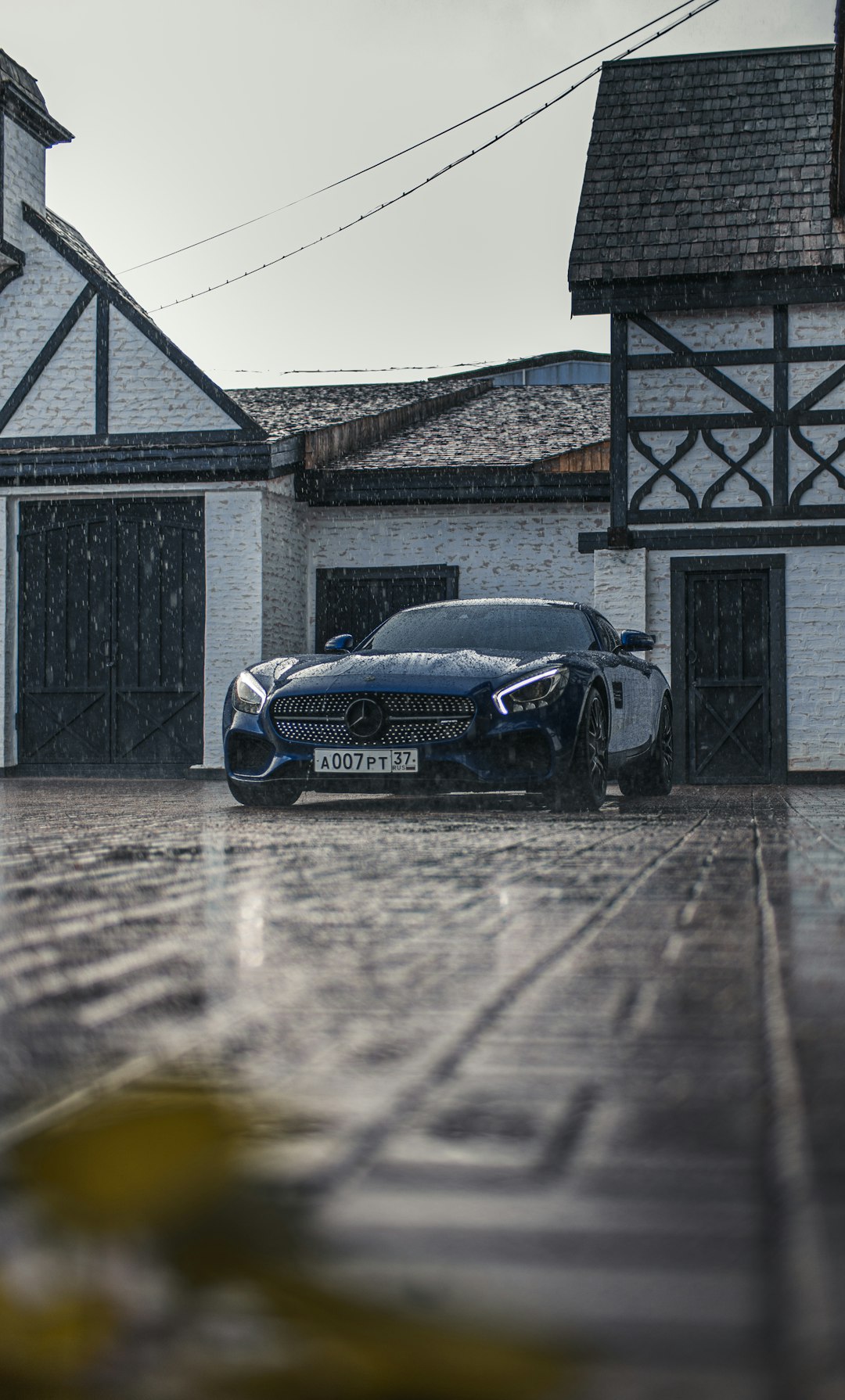 black bmw m 3 coupe parked beside gray wooden house