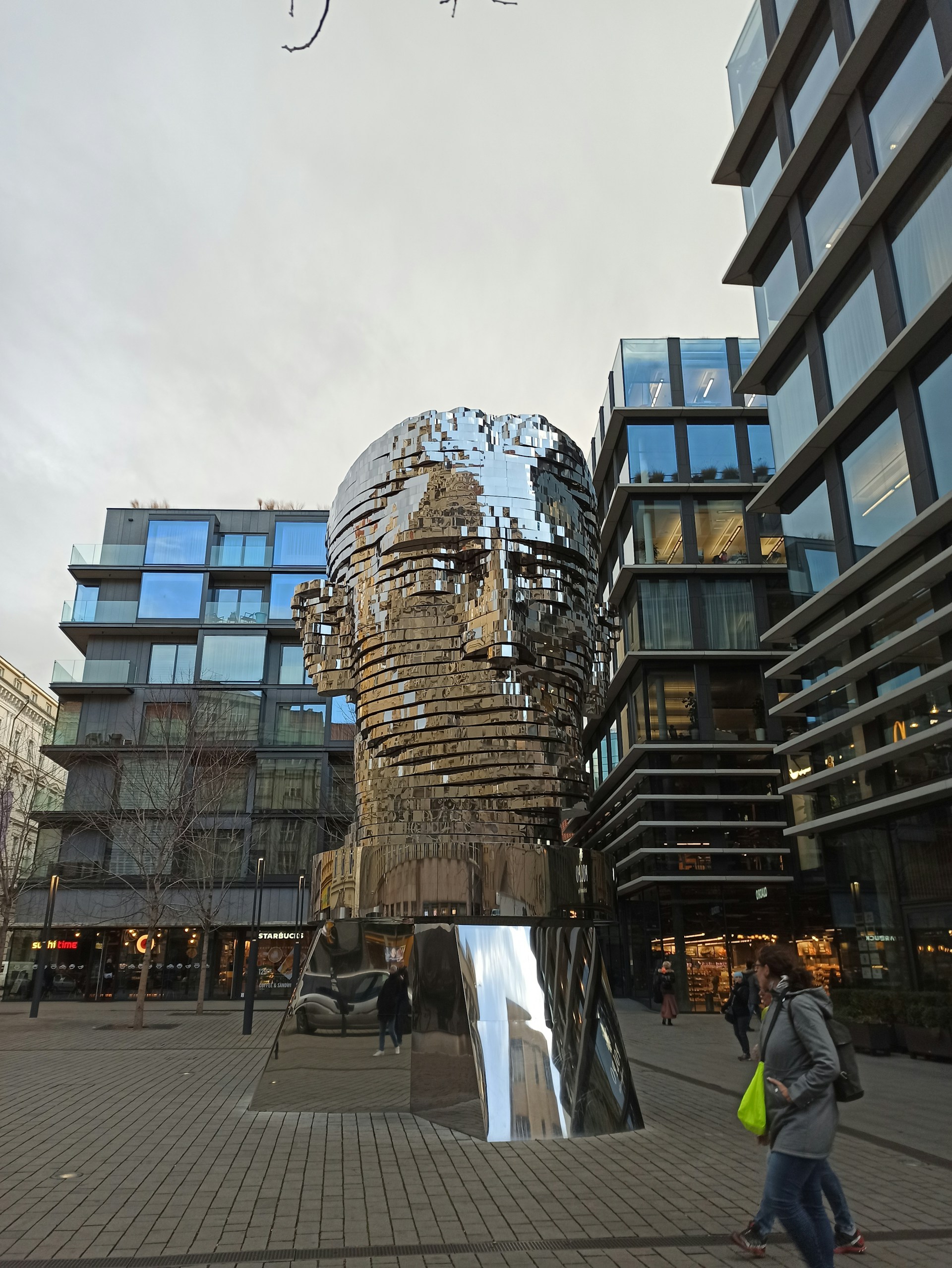 An outdoor installation of a large-scale kinetic sculpture interacting with natural light and shadows.